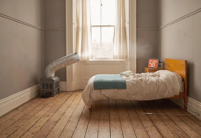 Professional heat treatment setup in a Waltham Forest bedroom for bed bug removal, thermometer showing 58°C.